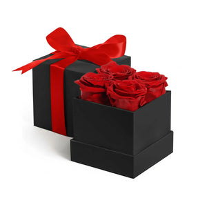 Black gift box with red satin ribbon and 4 real preserved red roses inside
